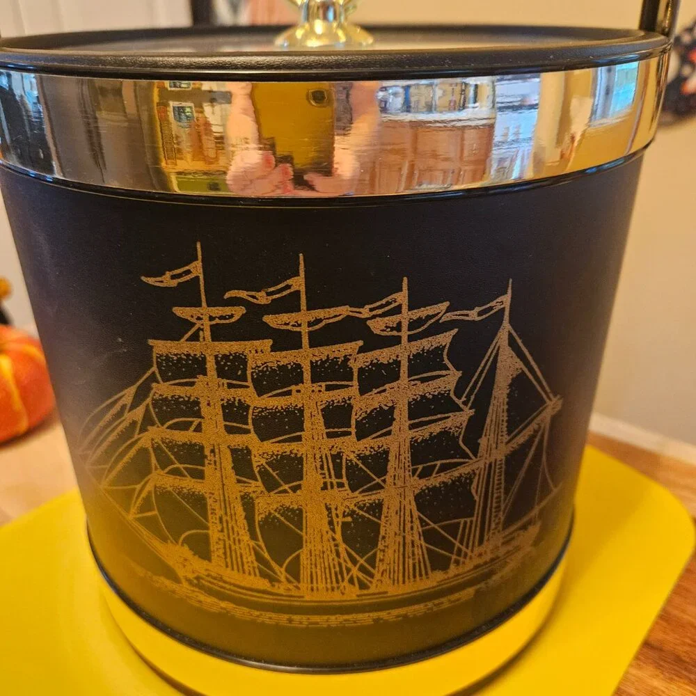 vintage ice bucket black with a sailboat design with a gold touch